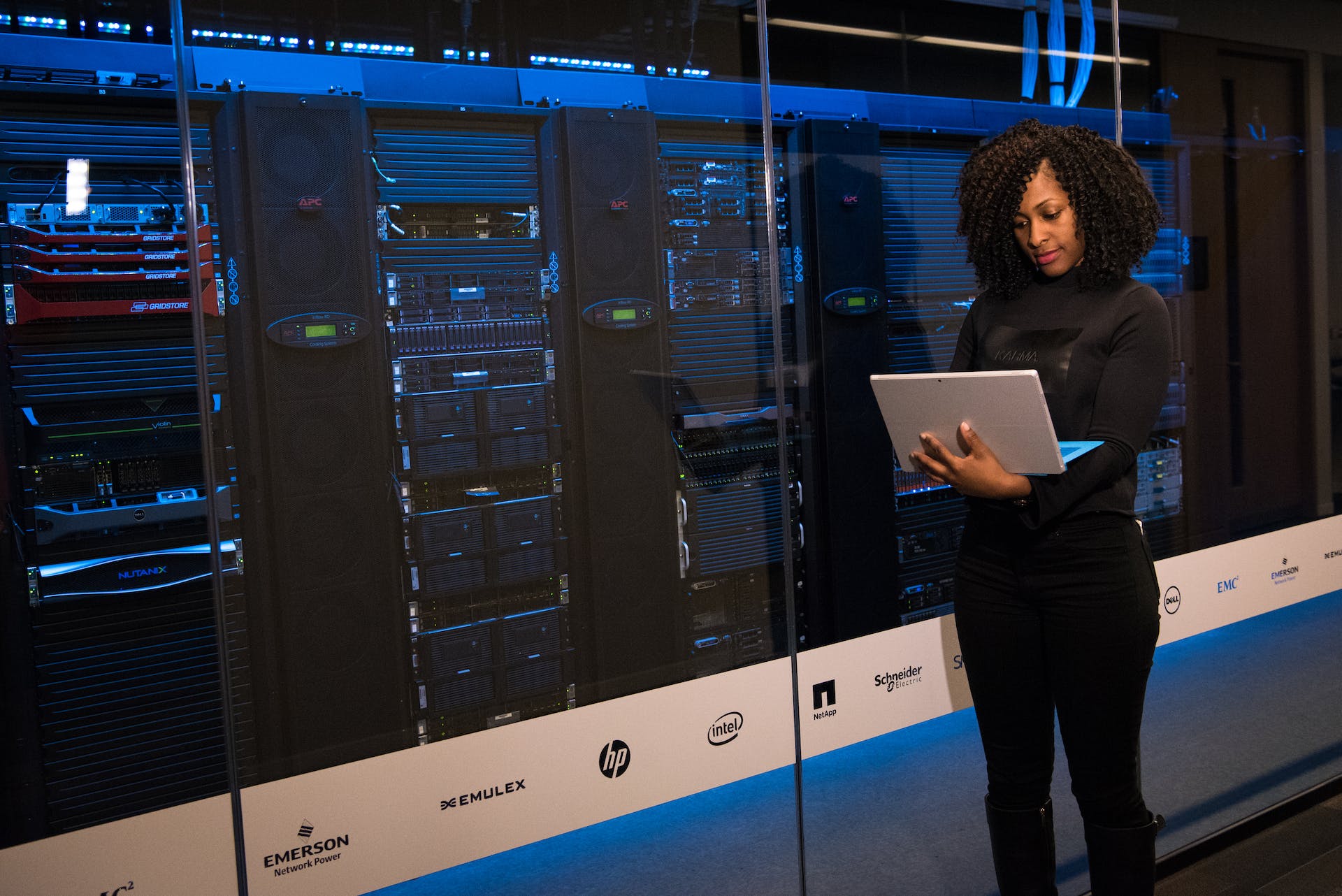 a woman working on a laptop in a data center | Data Center Energy Usage