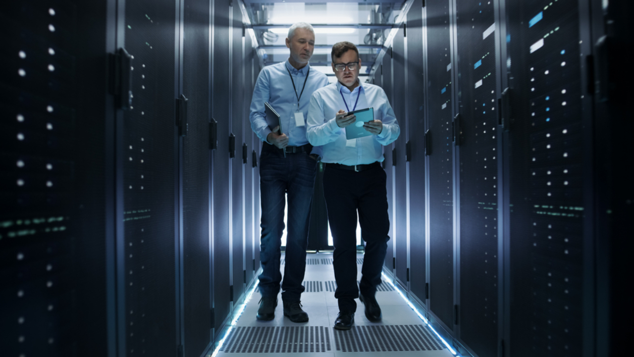 two men walking in a data center | Data Center Business