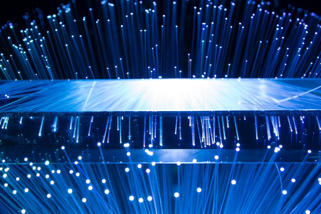 a large display of blue lights in a dark room | Fiber Optic Internet