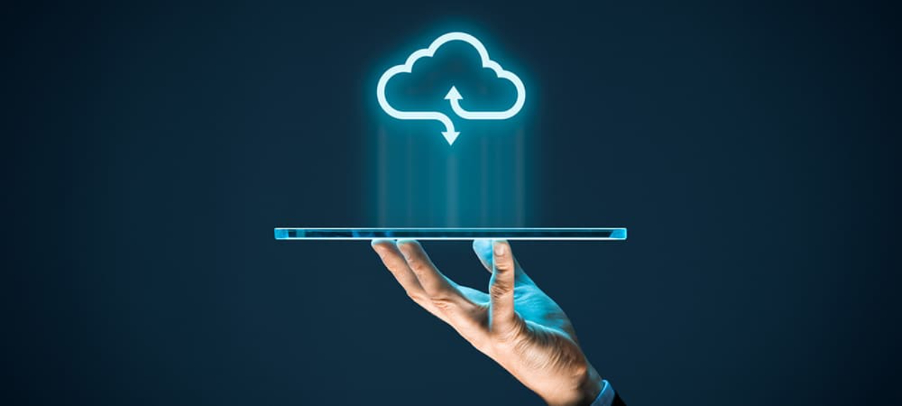a cloud symbol projected over a tablet screen | Cloud Storage Solutions